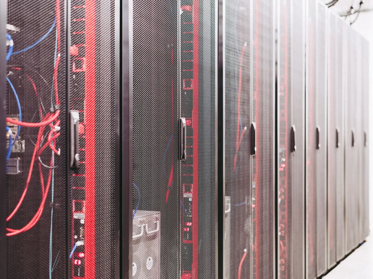Rows of server racks with patched cables