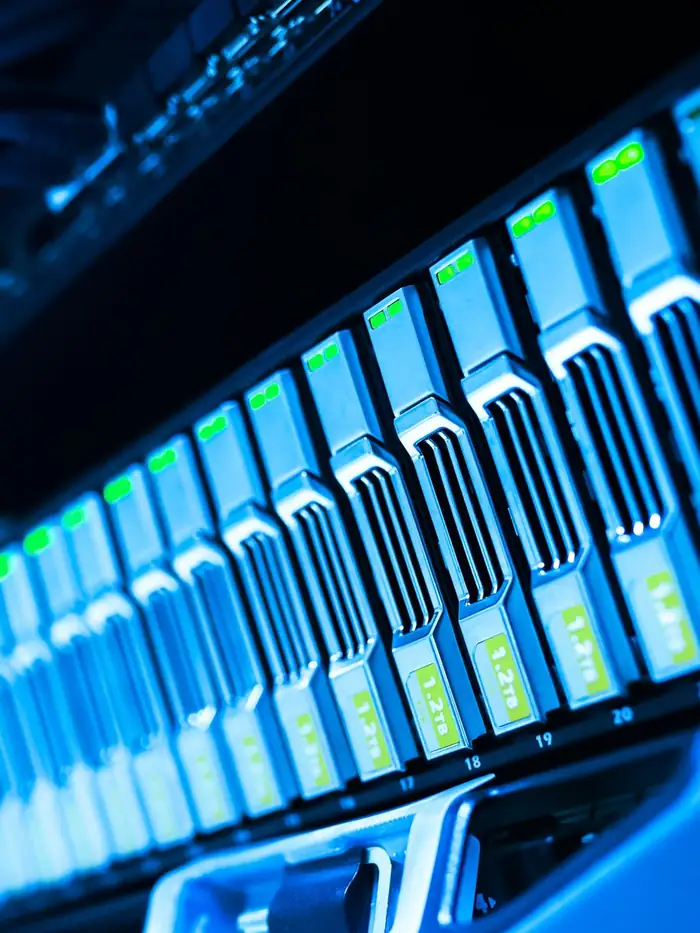 A rack of servers lit blue in a data center